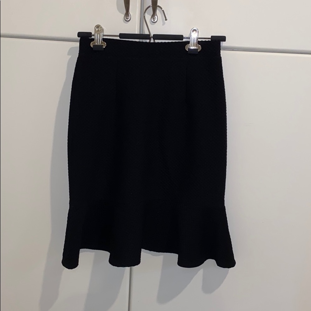 Black skirt wavy hemline.